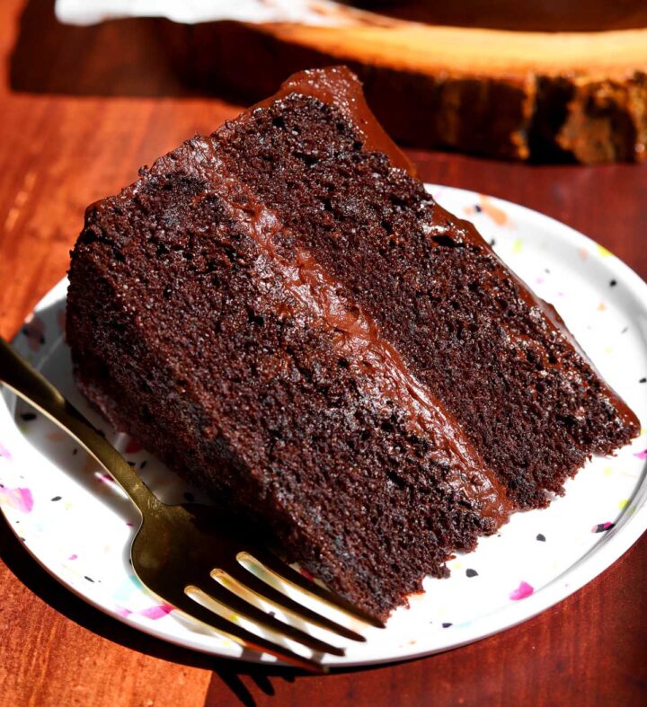 slice of best moist chocolate cake on a plate with fork