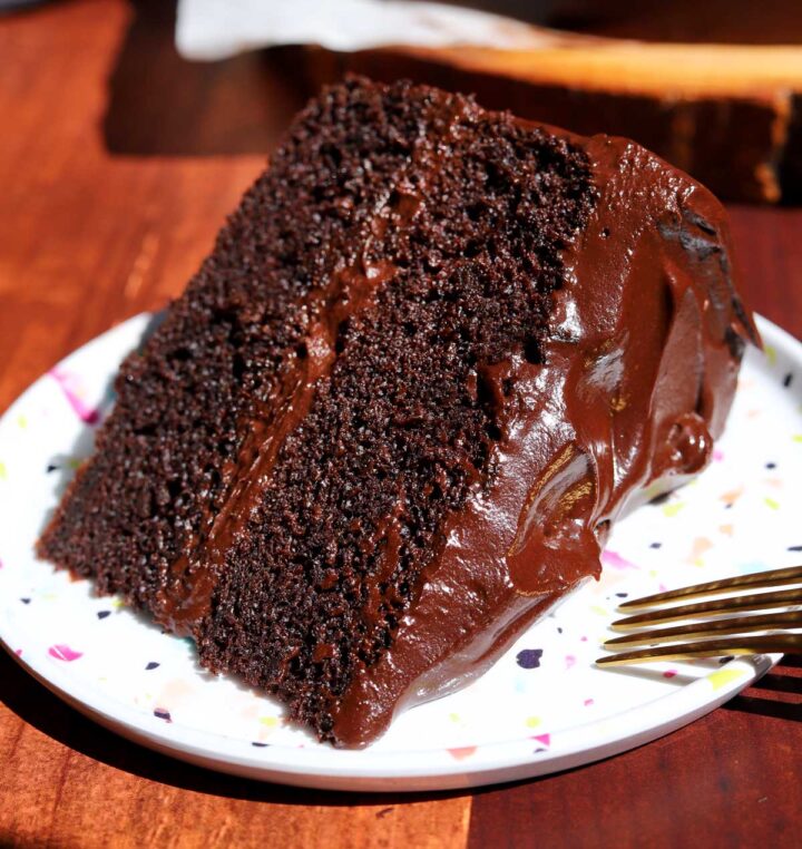 slice of best moist chocolate cake on a plate with fork