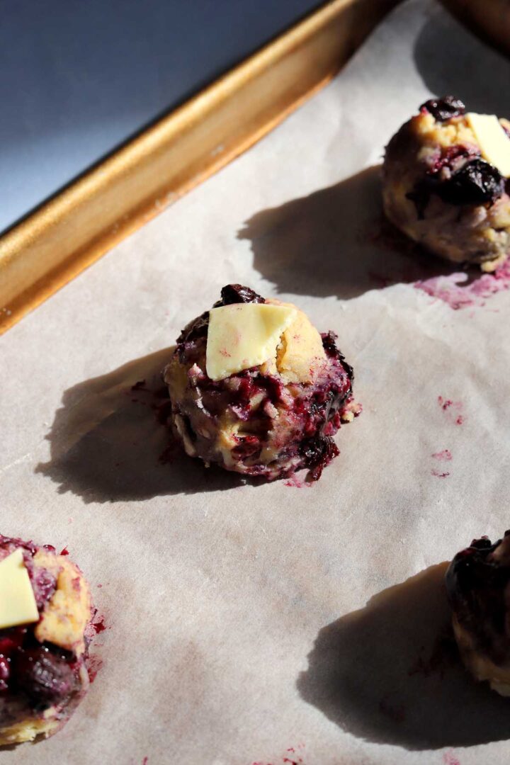 lemon blueberry cookie dough with white chocolate chunks on baking sheet