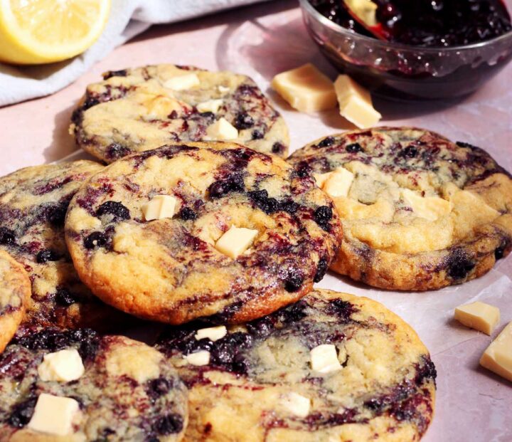 lemon blueberry cookies stacked on parchment