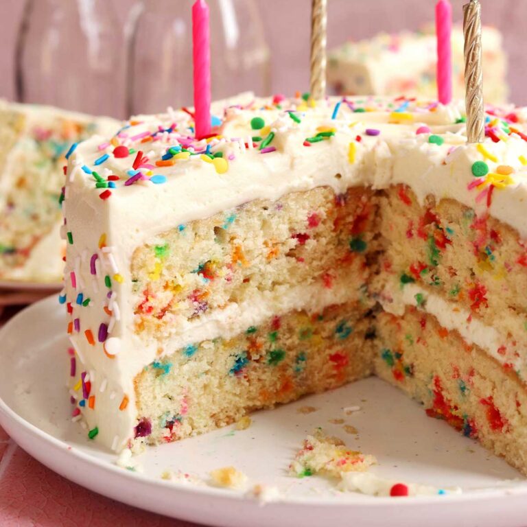 best funfetti cake on a plate with birthday candles