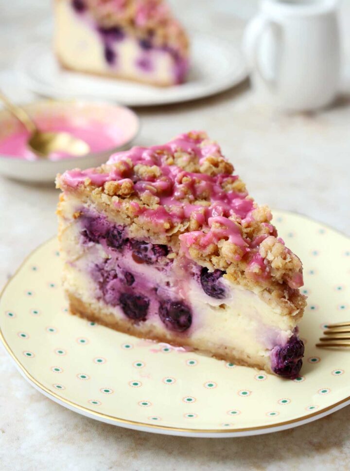 blueberry crumble cheesecake slice on a plate