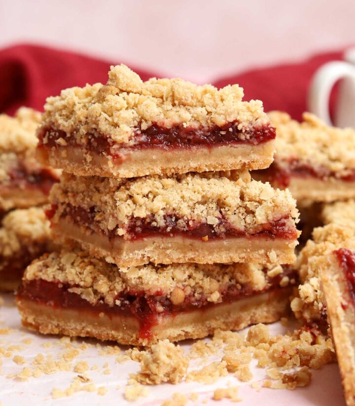 stack of sliced strawberry crisp bars on parchment paper