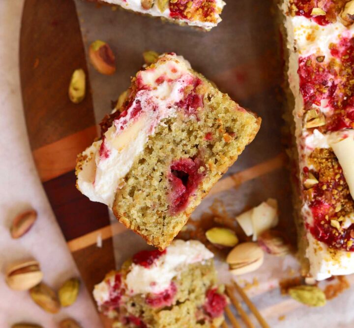 top view of raspberry pistachio cake slice showing cross section