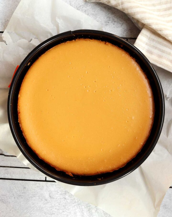 top view of salted caramel cheesecake in pan after baking