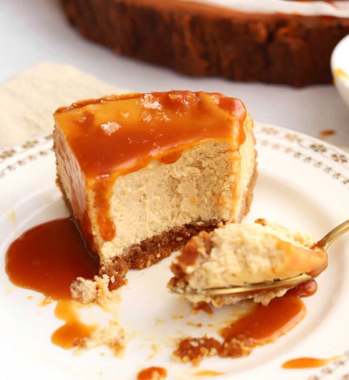 slice of salted caramel cheesecake on a plate with bite and fork