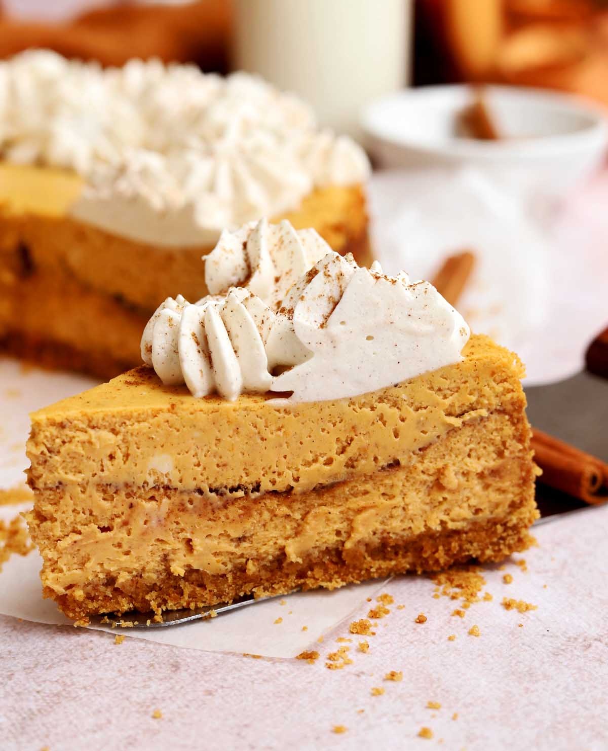 slice of cinnamon swirl pumpkin cheesecake on cake server