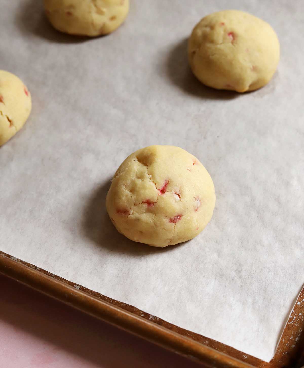 peppermint snowball cookies on cookie sheet after baking