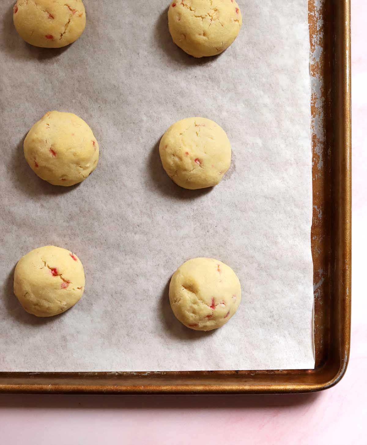 top view of peppermint snowball cookies on cookie sheet after baking