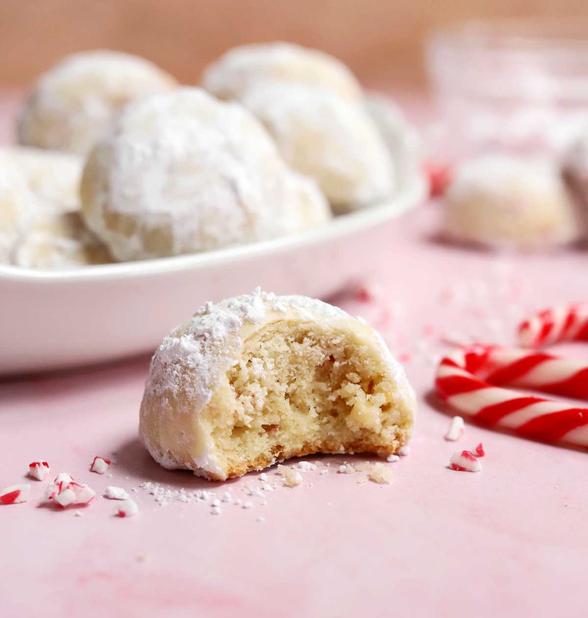 peppermint snowball cookies with bite showing tender insides