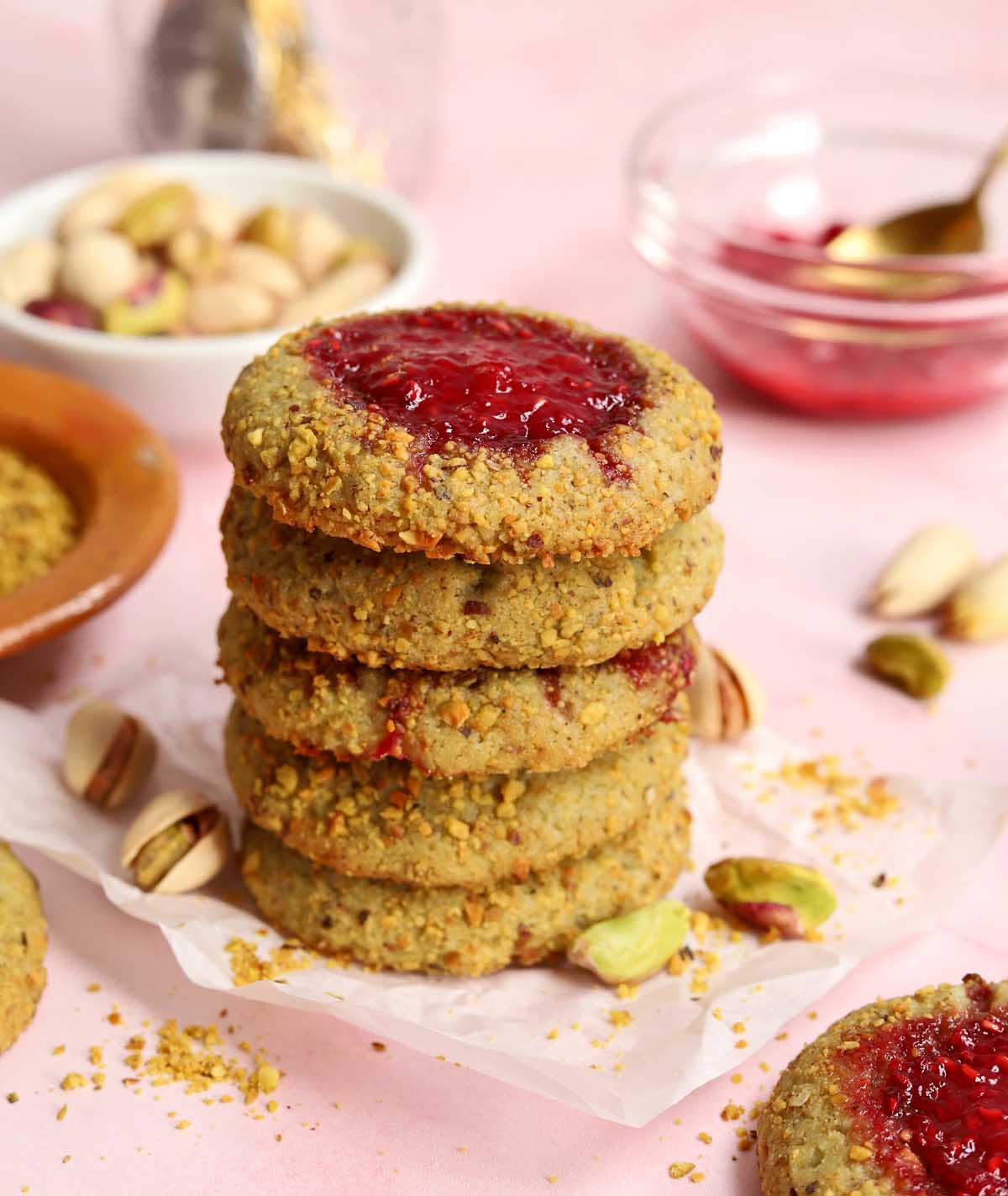 stack of raspberry pistachio thumbprint cookies