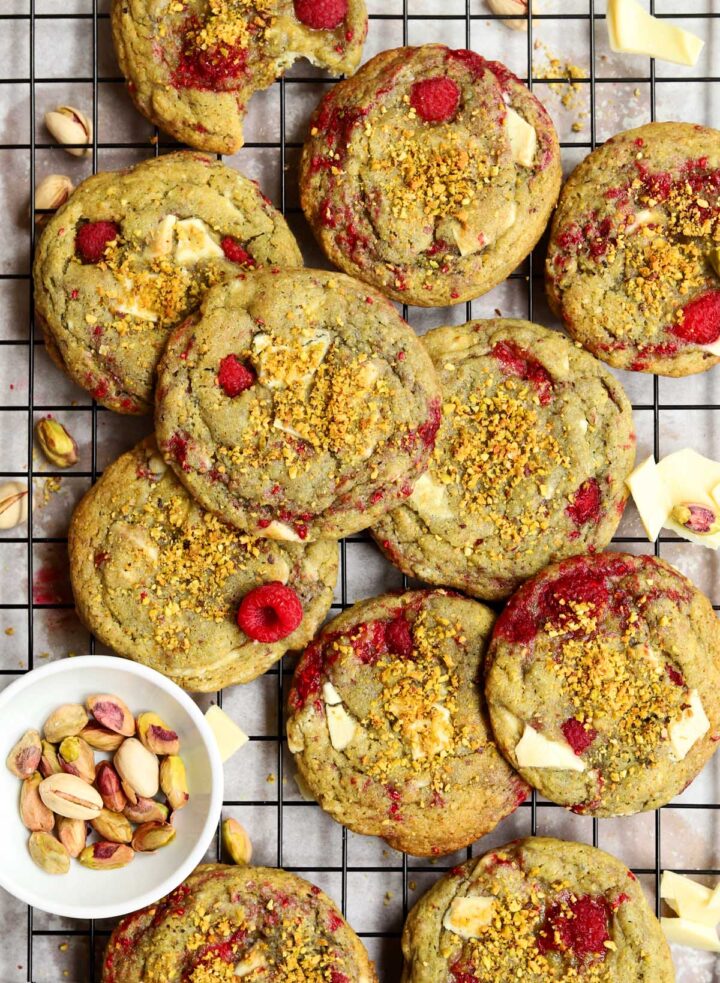 top view of white chocolate raspberry pistachio cookies on cooling rack over baking sheet