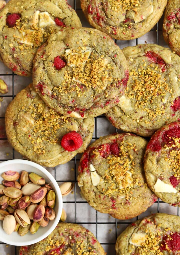 top view of white chocolate raspberry pistachio cookies on cooling rack over baking sheet