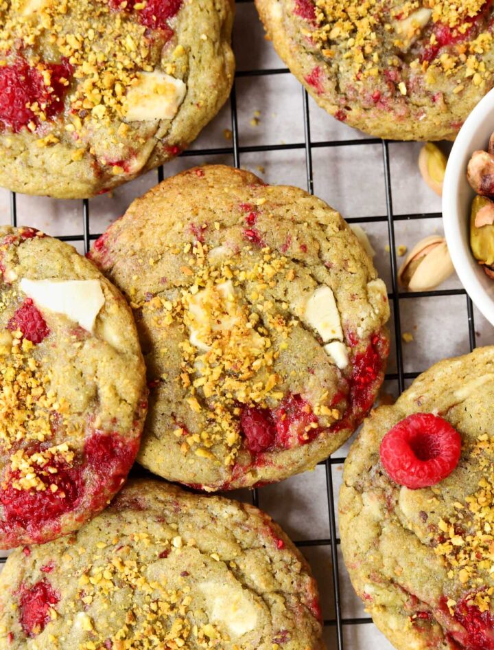 top view of white chocolate raspberry pistachio cookies on cooling rack over baking sheet
