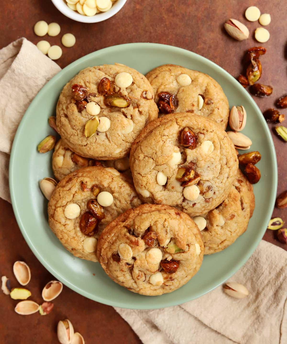 top view of caramelized pistachio brown butter white chocolate cookies on a plate