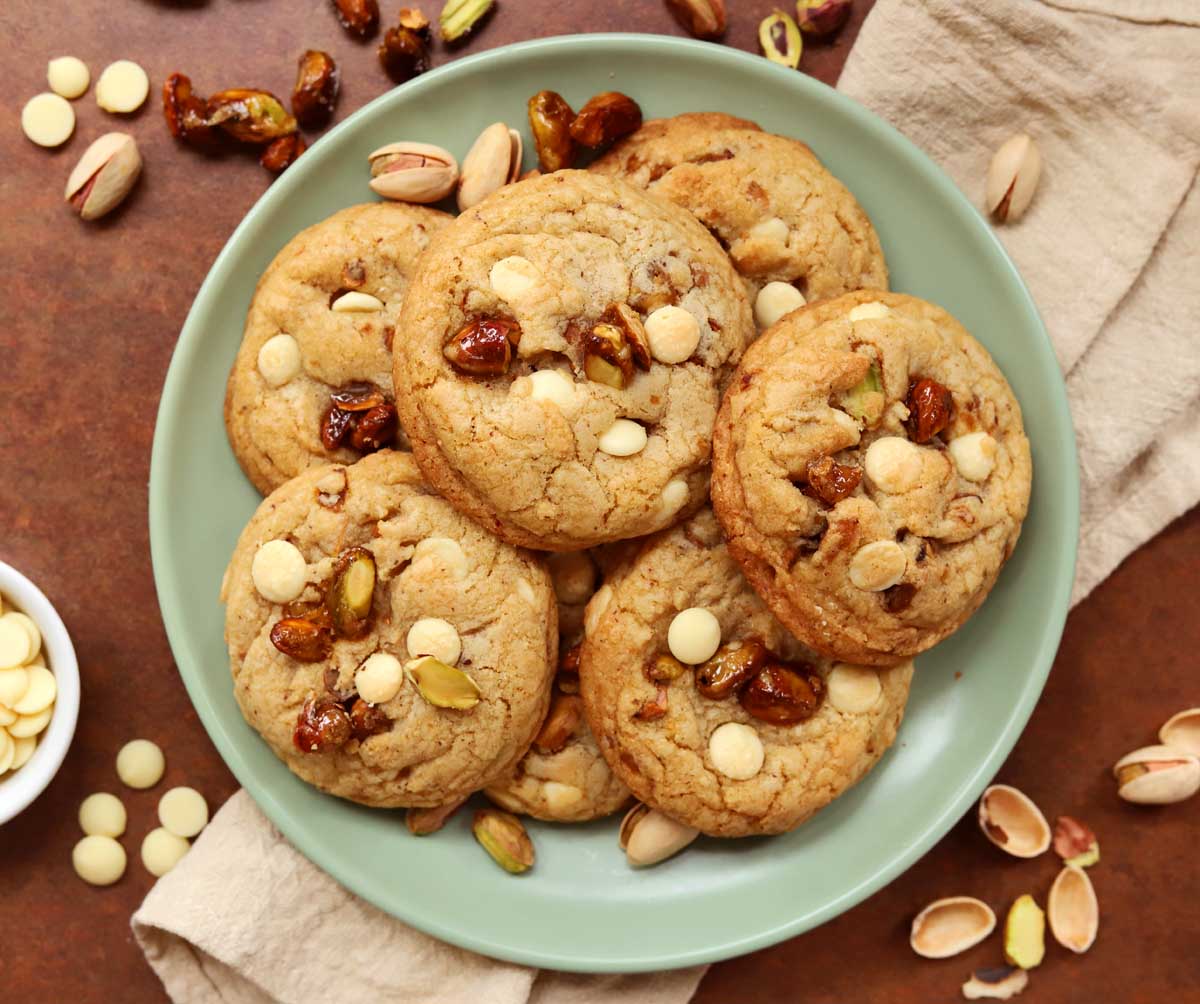 top view of caramelized pistachio brown butter white chocolate cookies on a plate
