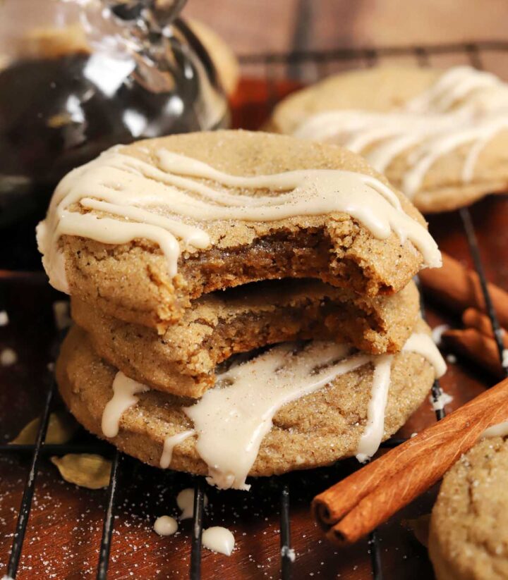 vanilla maple chai latte cookies stacked on cooling rack with bite