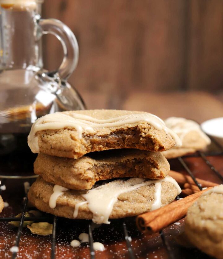 vanilla maple chai latte cookies stacked on cooling rack with bite