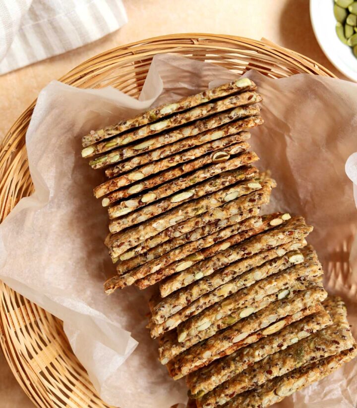 close up of super seed crackers in a bread basket