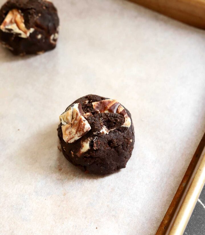 double chocolate cookies and cream cookie dough on parchment lined baking sheet