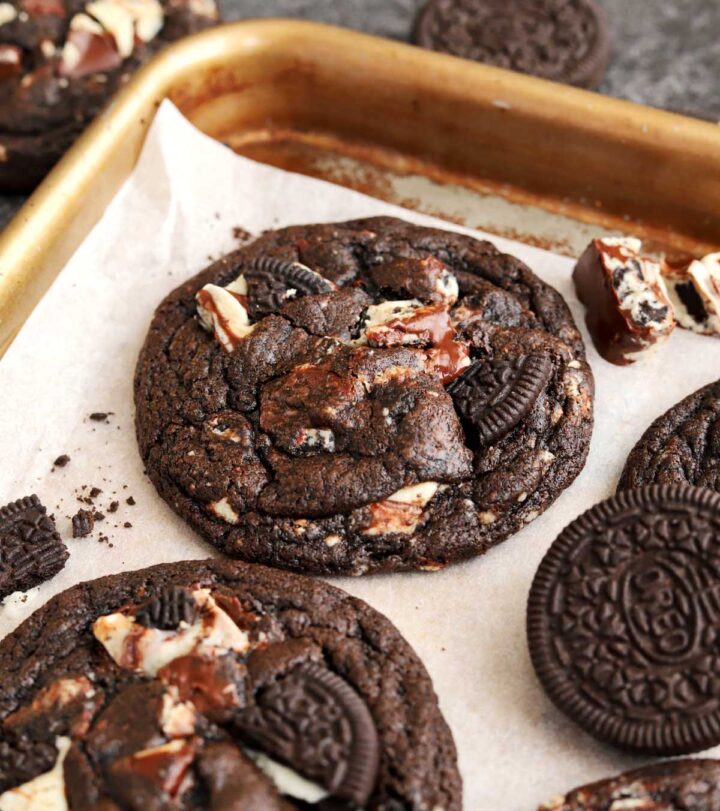 angle view of double chocolate cookies and cream cookies on baking sheet