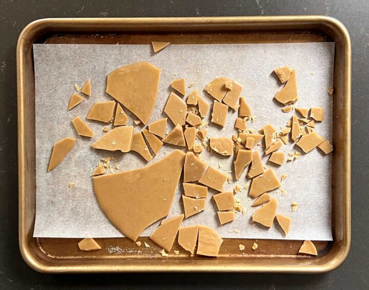 homemade toffee broken in pieces on baking sheet