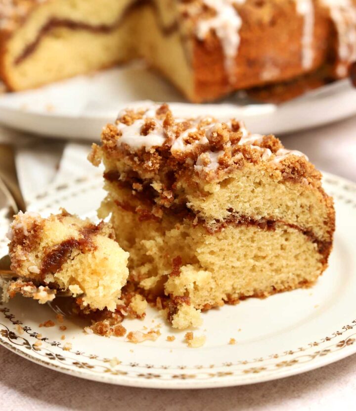 sour cream coffee cake slice on plate with bite on a fork
