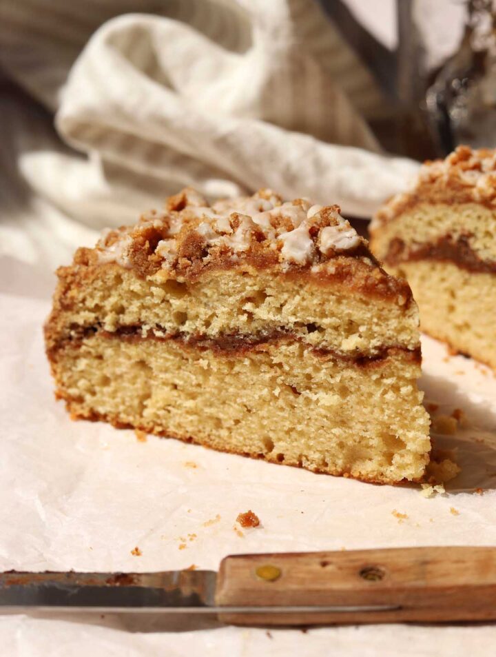 sour cream coffee cake slice on table showing cinnamon ribbon