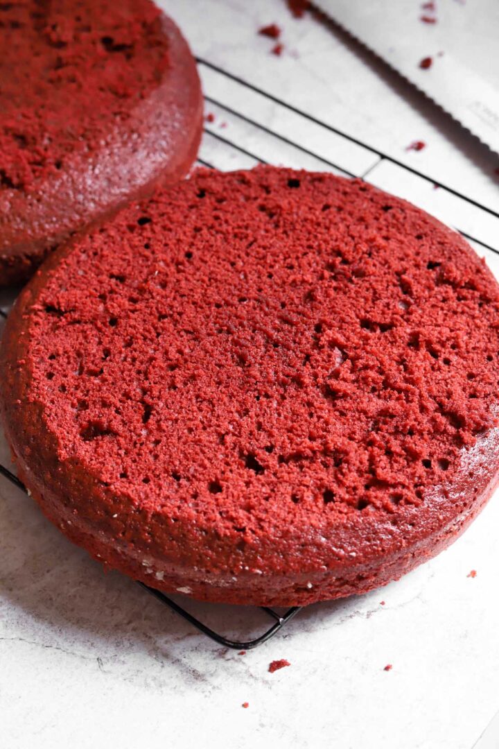 red velvet cake layer with top trimmed off showing crimson crumb