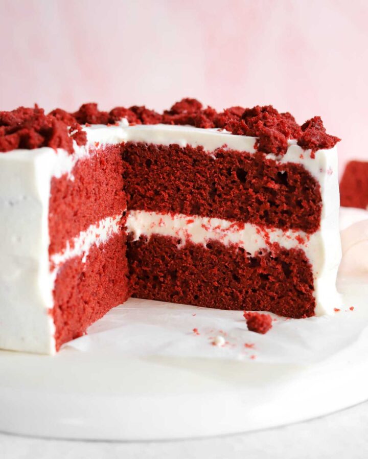 front view of sliced red velvet cake showing red crumb cross section