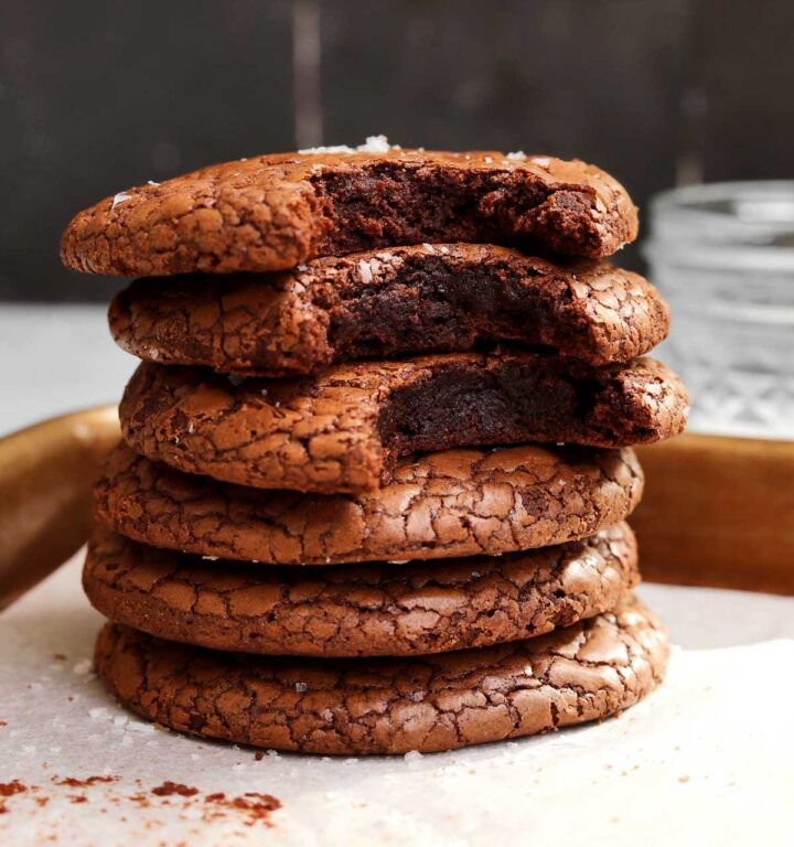 stack of small batch brownie cookies with bite showing fudgy texture