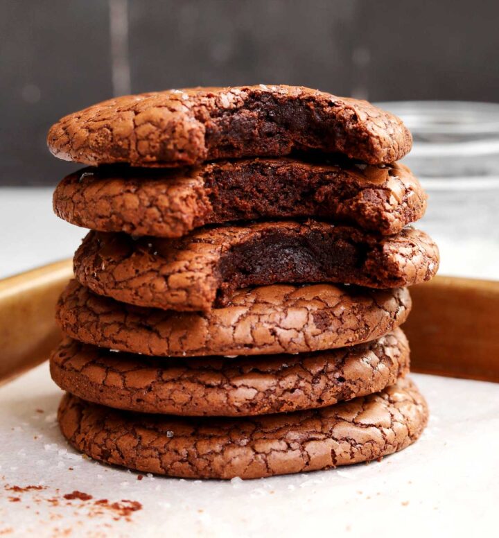 small batch brownie cookies stacked with bite showing fudgy texture