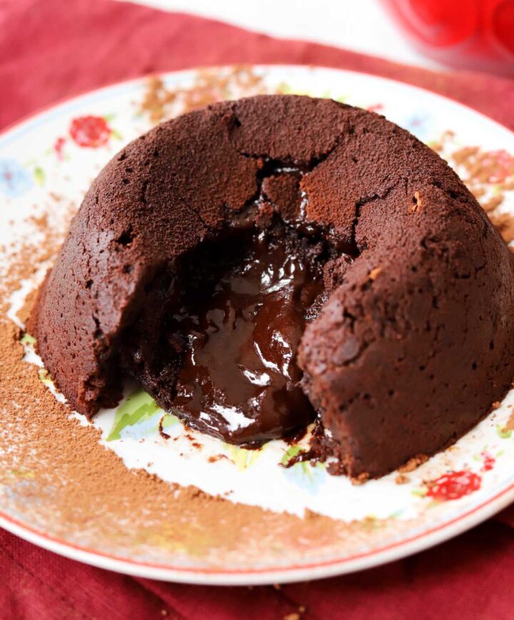 molten chocolate lava cake on a plate showing molten center flowing out