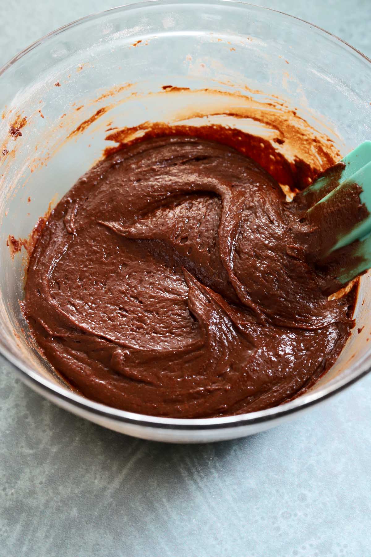 chocolate fondant cookie batter in mixing bowl with spatula
