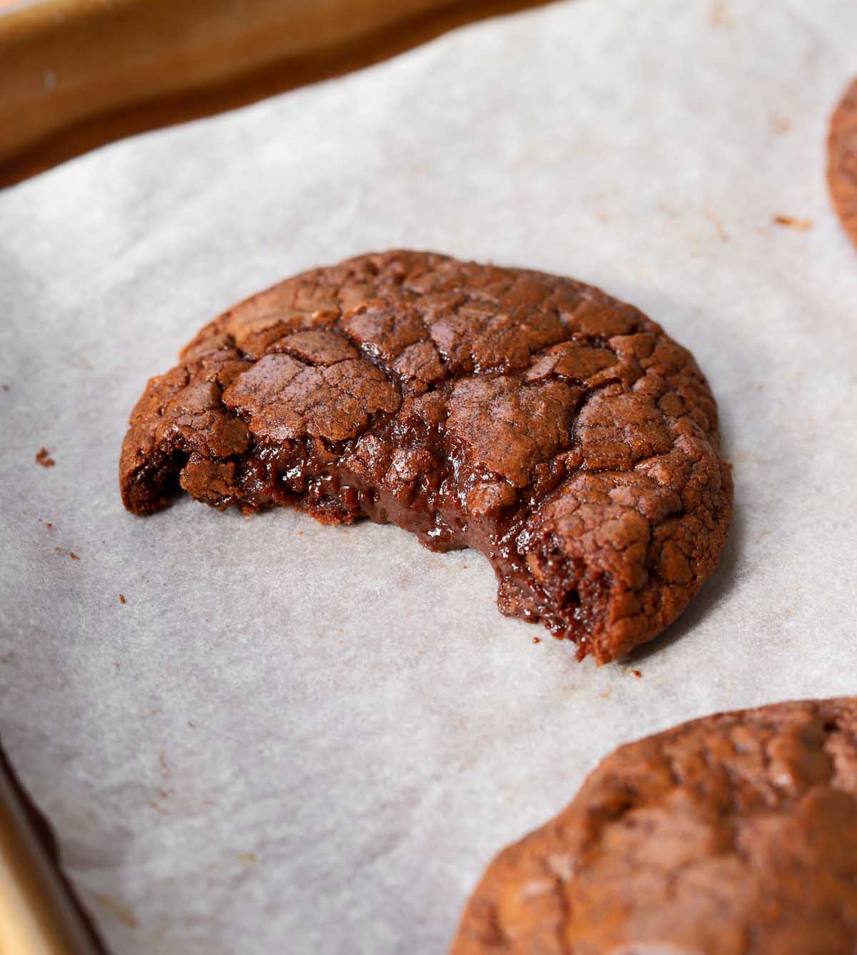 chocolate fondant cookie with bite on baking sheet