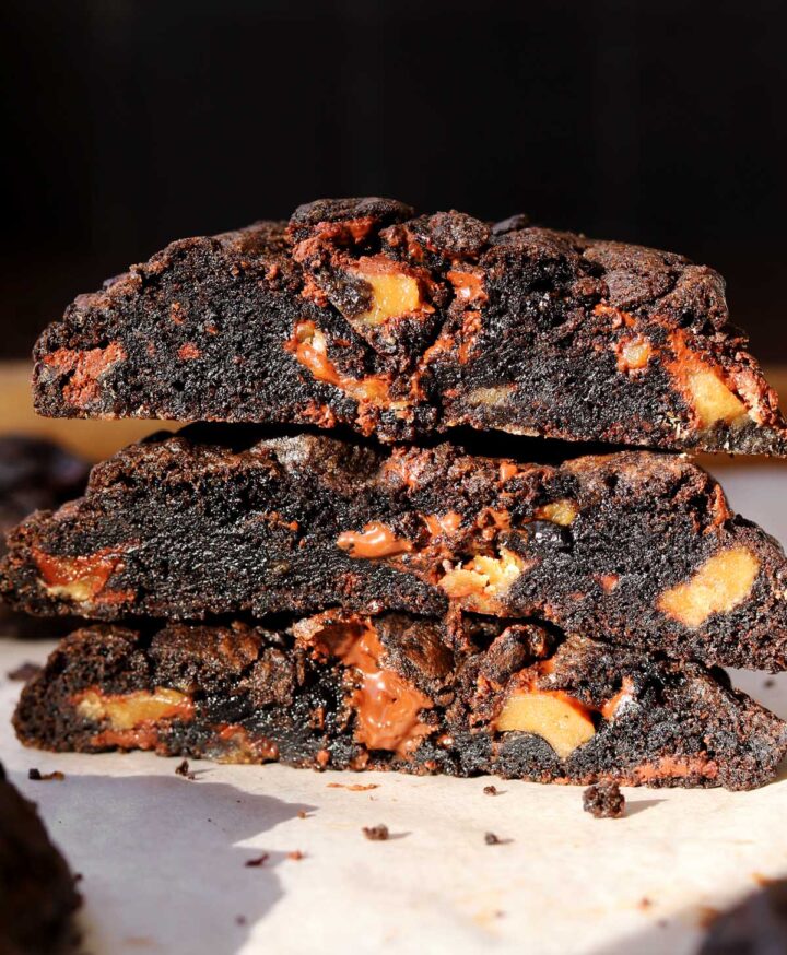 levain bakery coffee toffee cookies cut in half and stacked showing fudgy centers