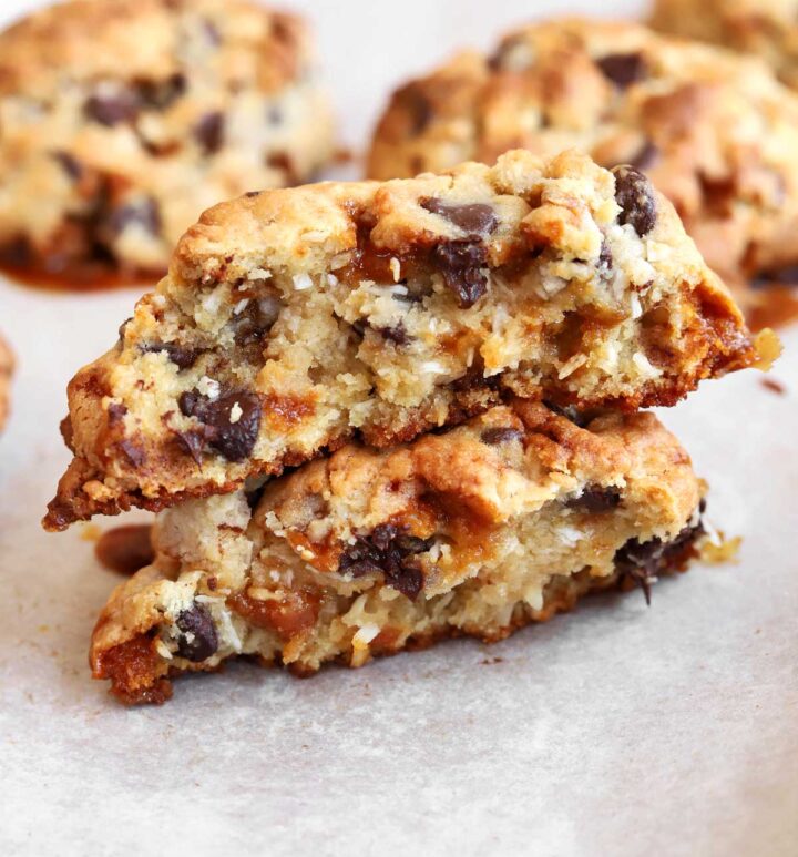 levain bakery caramel coconut cookie broken in half showing chewy center on baking sheet