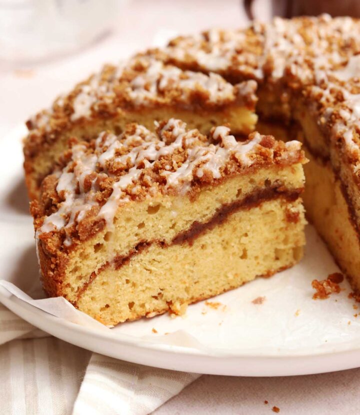 sour cream coffee cake on plate with slice cut out