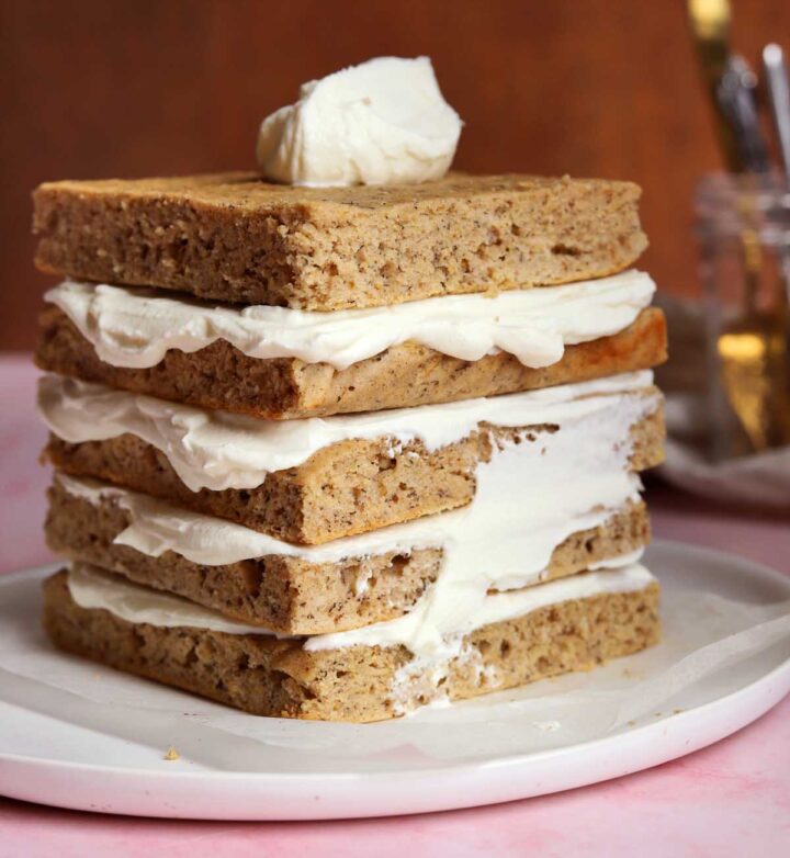 sugar free smash cake layers stacked with sugar free cream cheese frosting