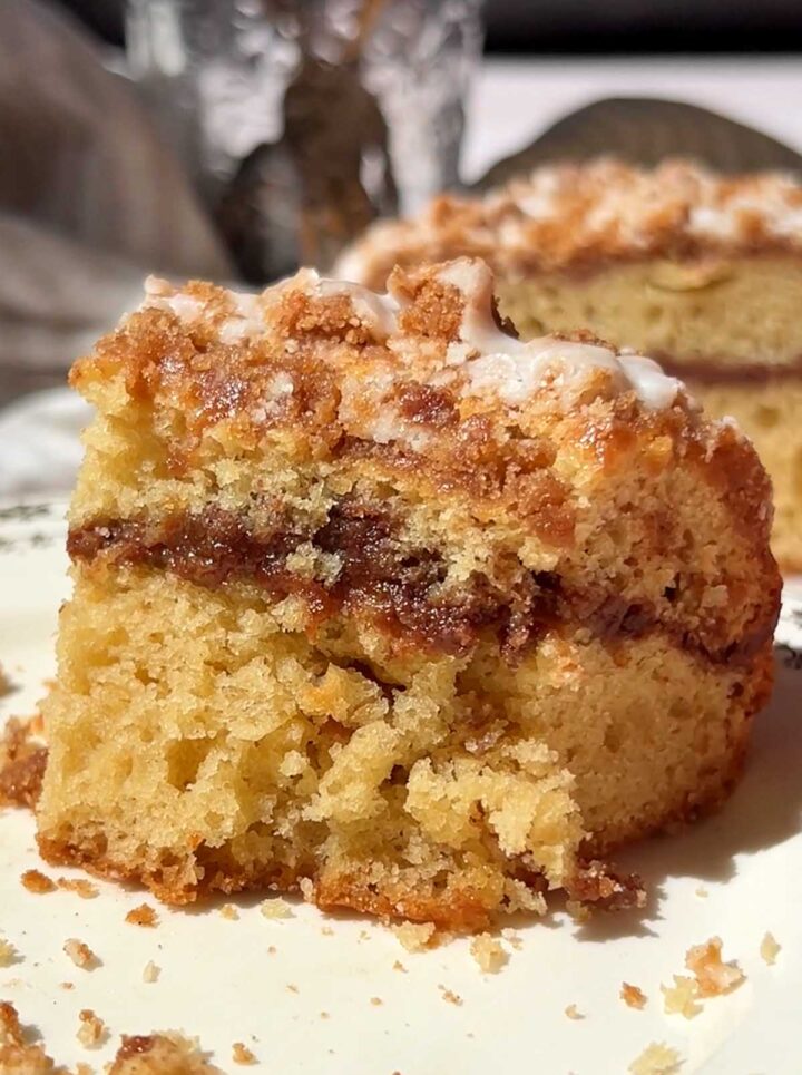 slice of sour cream coffee cake on a plate with bite