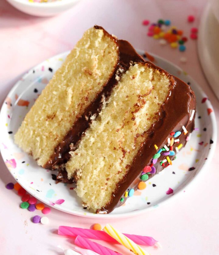 slice of classic vanilla birthday cake on plate