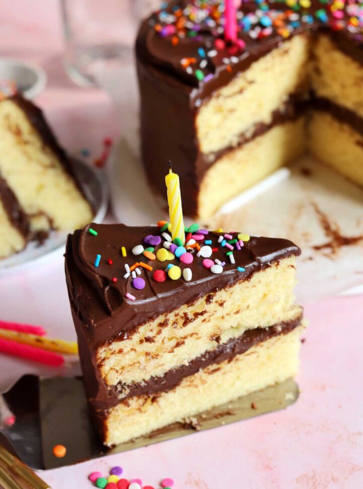 slice of classic vanilla birthday cake on cake server