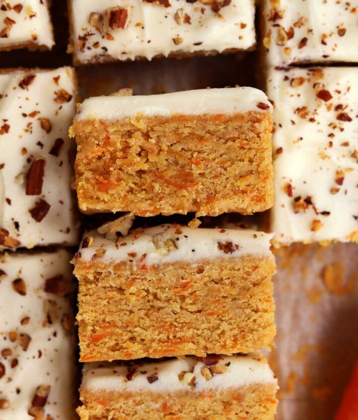 sliced carrot cake bars with cream cheese frosting showing inside texture