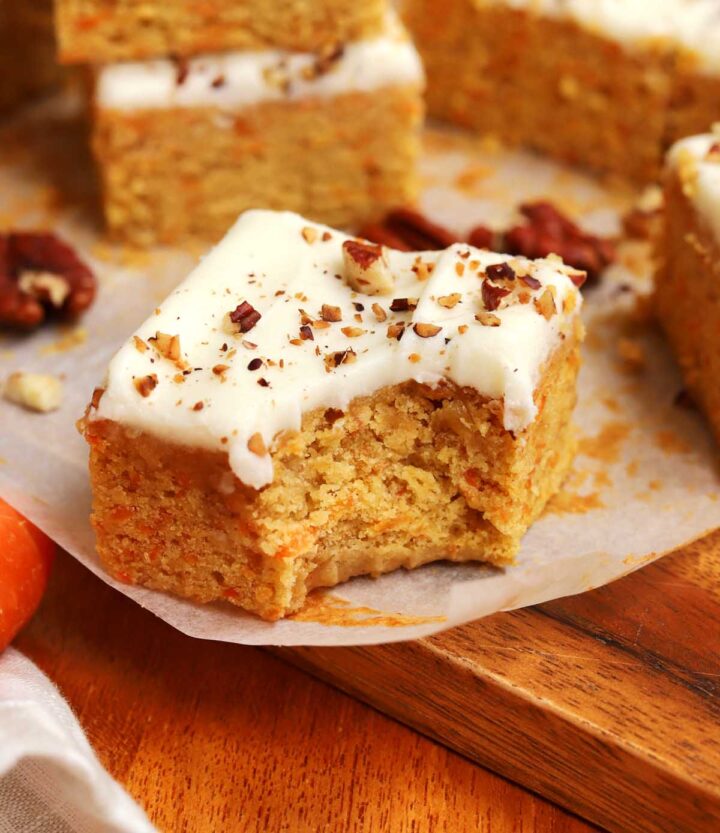 carrot cake bar on cutting board with bite