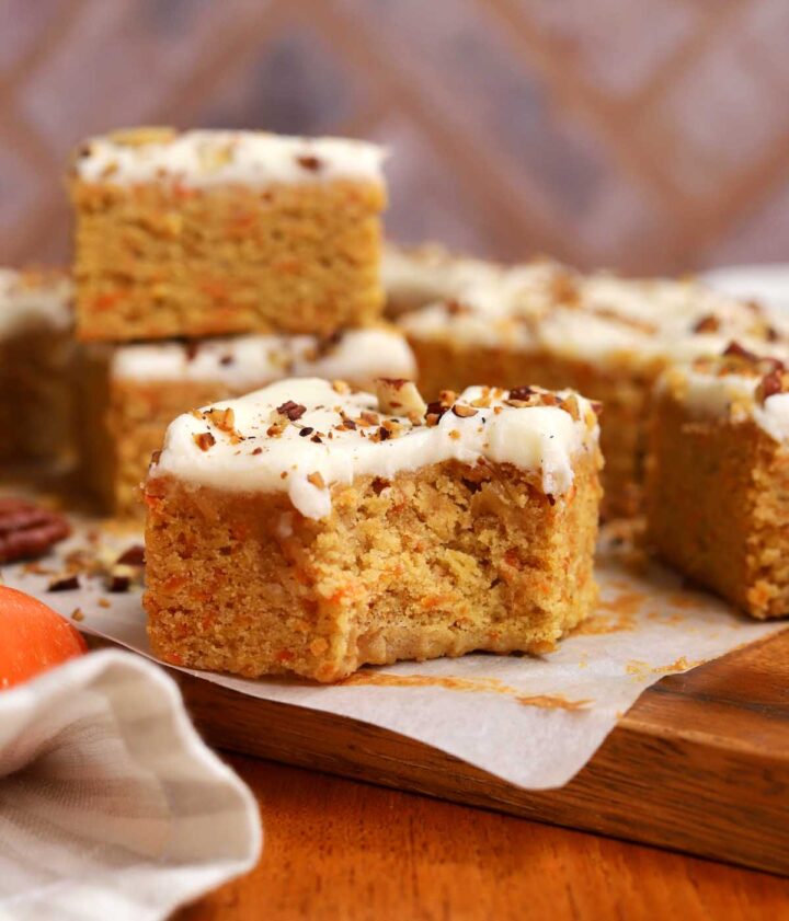 carrot cake bar on cutting board with bite