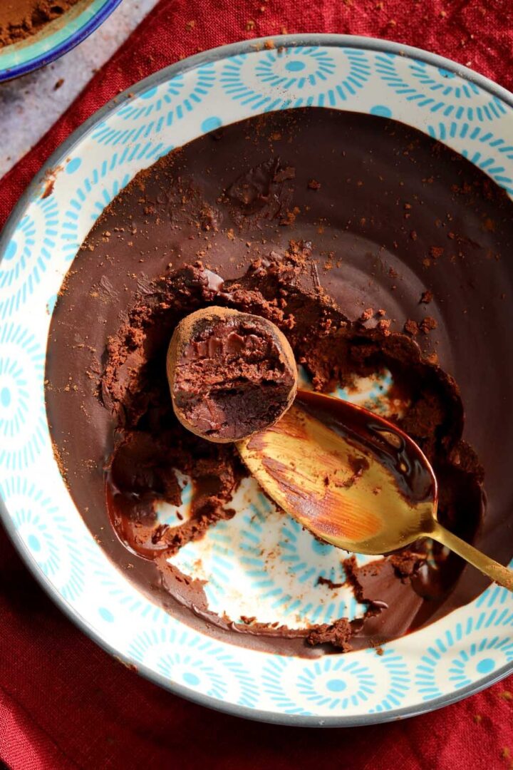 one ingredient chocolate water truffles with bite in bowl with ganache