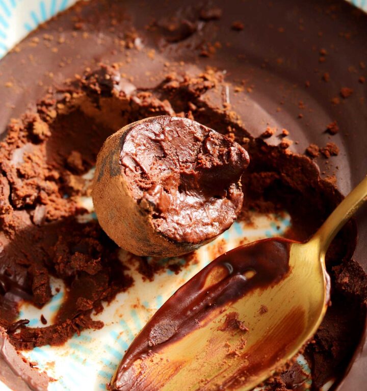 one ingredient chocolate water truffles with bite in bowl with ganache and spoon