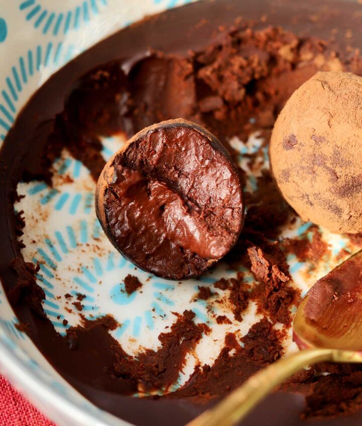 one ingredient chocolate water truffles with bite in bowl with ganache