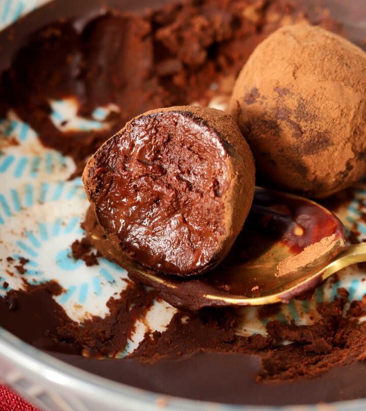 one ingredient chocolate water truffles with bite in bowl with ganache and spoon