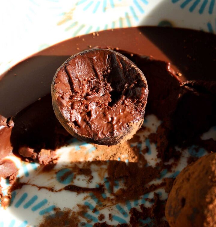 one ingredient chocolate water truffles with bite in bowl with ganache